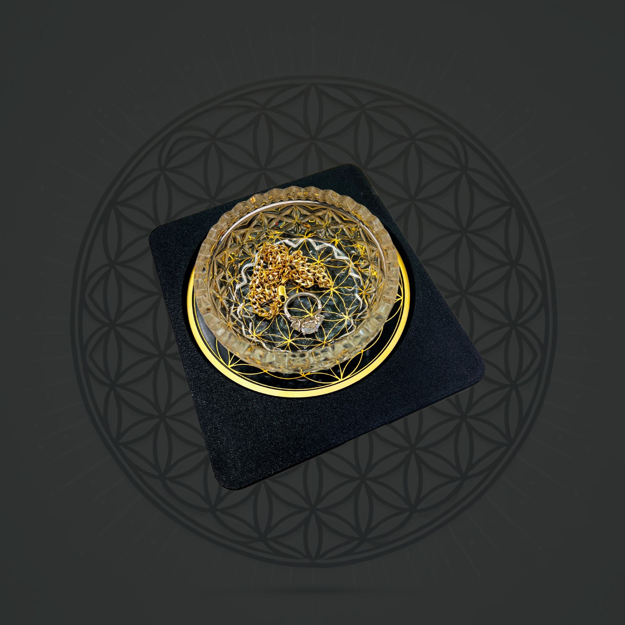 Sacred Ritual Oils Metatronic Flower of Life Frequency Imprinter with golden chain and ring on black and gold base